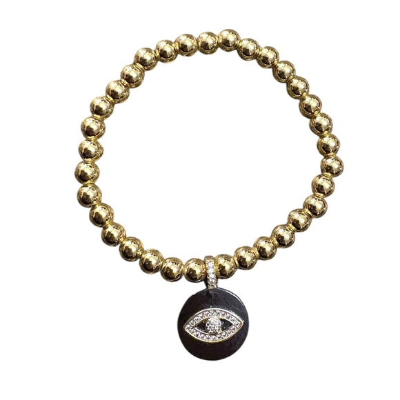 Jewelry - Gold tone beaded elastic bracelet with black and rhinestone evil eye pendant